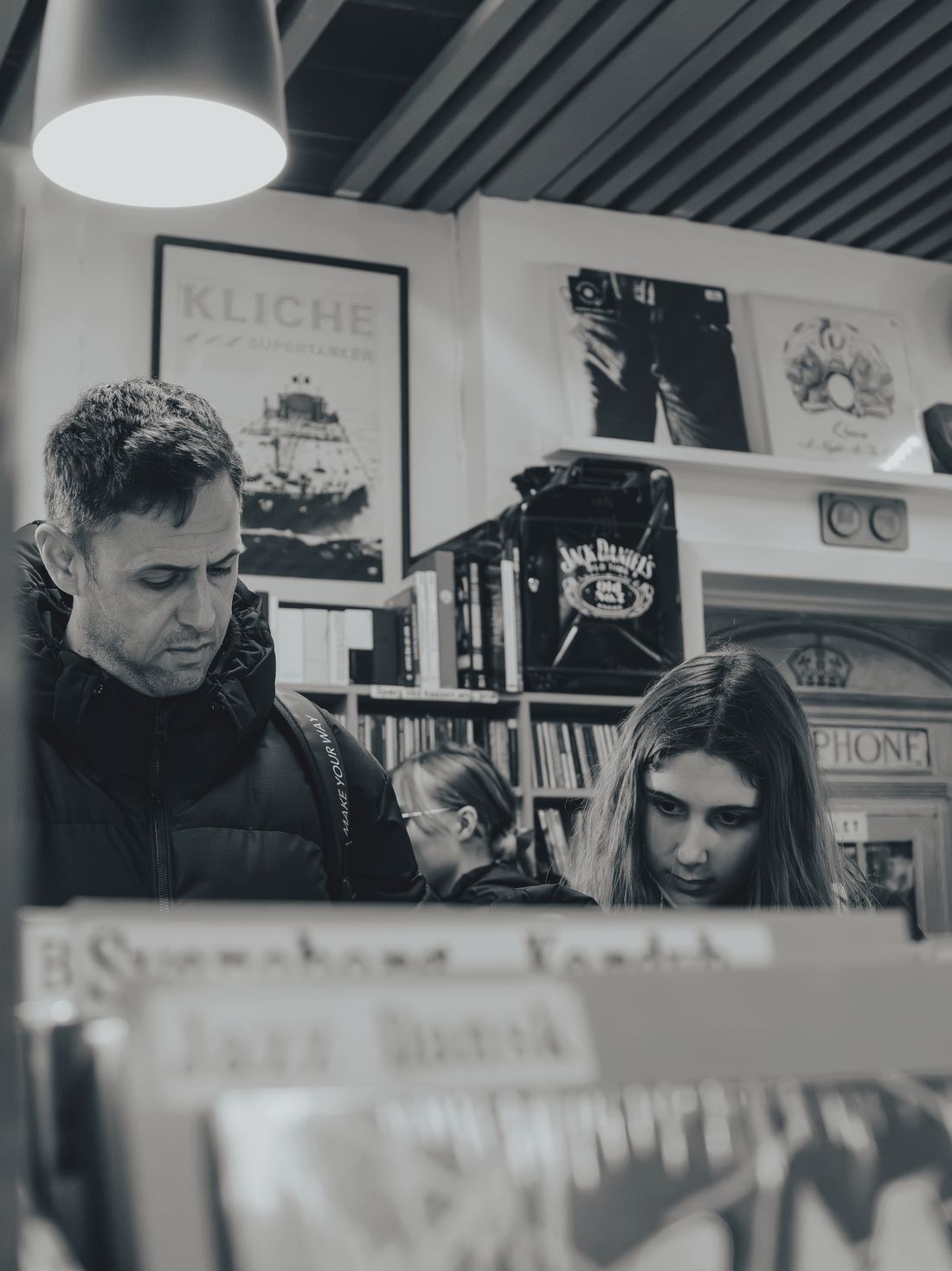 A father and daughter looking through records in a shop